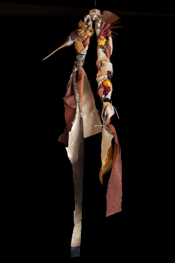 A bespoke, handmade costume piece made from assorted found and upcycled objects on a black background. The costume has a futuristic, post-apocalyptic look. 