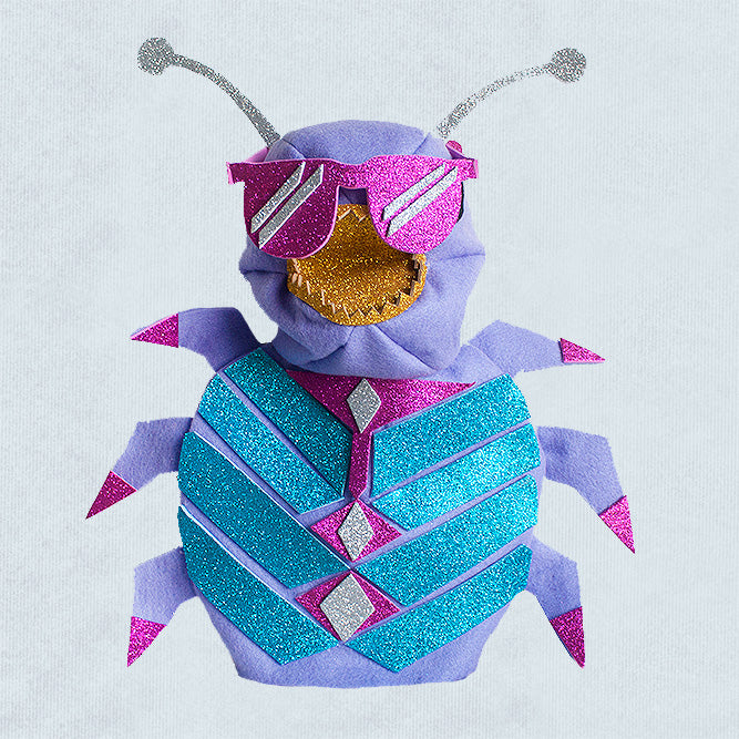 A colourful, glittery, handmade felt beetle puppet wearing glitter sunglasses. 