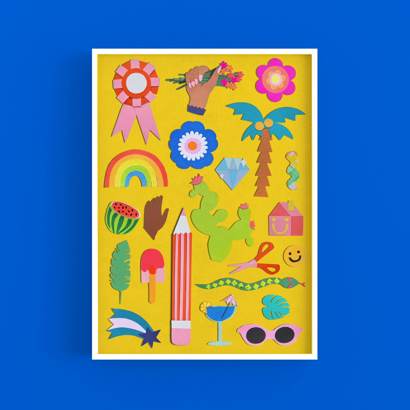 A colourful A3 art print of a papercraft collage depicting various motifs and shapes cut from coloured cardstock, on a yellow background. The print sits in a white frame on a bright blue background.