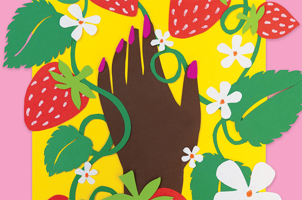 Close up detail shot of an A3 art print of a papercraft collage artwork. The print depicts strawberries and a brown hand with pink nail polish against a yellow and pink background. The print is in a white frame on a yellow background.